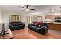 Comfortable living room with hardwood floors, ceiling fan, and a seamless transition to dining area at 4255 S Marisol Ln, Gilbert, AZ 85297