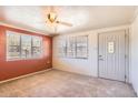 Bright living room featuring neutral carpet, abundant natural light, and a ceiling fan at 4518 N 8Th Pl, Phoenix, AZ 85014
