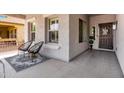 Cozy front porch features decorative seating, neutral stucco exterior, and a stylish entrance at 4606 S Marron --, Mesa, AZ 85212