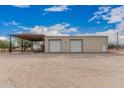 Spacious garage with two large bay doors, sheltered area, and adjacent door at 51089 W Julie Ln, Maricopa, AZ 85139