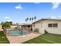 Backyard featuring a fenced pool, lush grass area, and a covered patio ideal for outdoor living at 6912 N 19Th St, Phoenix, AZ 85016