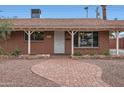 Close up shot of a charming home's brick pathway and desert landscaping at 8137 E Indianola Ave, Scottsdale, AZ 85251