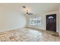 Open concept living area with tile flooring, ceiling fan, and natural light at 8137 E Indianola Ave, Scottsdale, AZ 85251