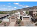 Aerial view of a stunning home with a three-car garage, desert landscaping, and a mountain backdrop at 8817 S 18Th Way, Phoenix, AZ 85042