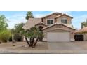Charming two-story home featuring desert landscaping, a two-car garage and tile roof at 9509 W Tonopah Dr, Peoria, AZ 85382