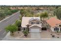 A charming two-story home featuring desert landscaping, a two-car garage and solar panels on the roof in quiet neighborhood at 9509 W Tonopah Dr, Peoria, AZ 85382