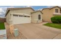 View of a two-car garage in a single-story home with desert landscaping at 9834 E Fairview Ave, Mesa, AZ 85208