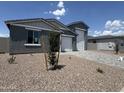 Inviting home with an attached three car garage and desert landscaping, perfect for low maintenance at 15790 W Cheryl Dr, Waddell, AZ 85355