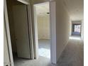 A bright hallway with doors leading to various rooms, showcasing the home's layout at 15790 W Cheryl Dr, Waddell, AZ 85355