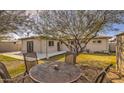 The backyard features a patio, a table with four chairs, and green grass at 2823 N 69Th Pl, Scottsdale, AZ 85257