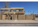 Charming two-story townhome featuring secure gated front yard and neutral stucco finish at 4614 E Pueblo Ave, Phoenix, AZ 85040