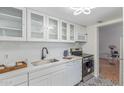 Well-lit white kitchen with modern countertops, appliances, and patterned floor at 4727 E Lafayette Blvd # 117, Phoenix, AZ 85018
