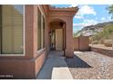 Close-up of home's entryway, showcasing stucco architecture and a walkway leading to the front door at 11451 E Christmas Cholla Dr, Scottsdale, AZ 85255