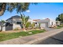 Charming single-story home with desert landscaping, paved driveway and attached garage at 11977 N 81St St, Scottsdale, AZ 85260