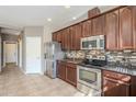 Well-equipped kitchen featuring stainless steel appliances and ample cabinet space at 13083 N 87Th Dr, Peoria, AZ 85381