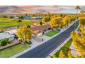 Beautiful neighborhood with well-manicured lawns, mature trees, and convenient street access at 18410 N 104Th Ave, Sun City, AZ 85373