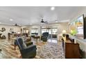 Cozy living room with comfortable seating, ceiling fans, and abundant natural light at 18410 N 104Th Ave, Sun City, AZ 85373