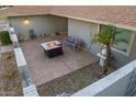 Serene backyard patio featuring a fire pit, bench, and tasteful decor for outdoor relaxation at 18410 N 104Th Ave, Sun City, AZ 85373