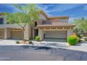 Lovely townhome with desert landscaping and attached 2 car garage with open door at 19700 N 76Th St # 2091, Scottsdale, AZ 85255
