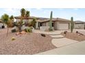 Inviting desert landscaping and concrete pathway to the front door of this beige home at 20017 N Cielo Ct, Surprise, AZ 85374