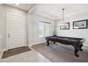 Bright, airy game room with a pool table, neutral carpet, and natural light, perfect for entertainment at 23060 E Sonoqui Blvd, Queen Creek, AZ 85142