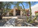 Inviting front exterior with stone landscaping, pathway, and charming architectural details at 23520 N 80Th Way, Scottsdale, AZ 85255