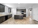 Spacious kitchen with dark cabinets and a center island at 24868 W Kowalsky Ln, Buckeye, AZ 85326