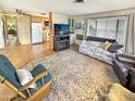 Open-concept living space with a cozy sofa, fireplace, and view into the well-lit kitchen area at 25 S 102Nd St # 73, Mesa, AZ 85208
