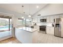 Bright and modern kitchen with white cabinets, stainless steel appliances, and a central island at 3149 W Danbury Dr, Phoenix, AZ 85053