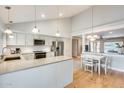 Bright, open kitchen with modern appliances, an island, and an adjacent dining area at 3149 W Danbury Dr, Phoenix, AZ 85053