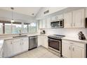 Well-lit kitchen with stainless steel appliances, white cabinets, and stylish countertops at 3149 W Danbury Dr, Phoenix, AZ 85053