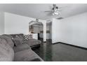 Bright living room featuring dark tile flooring and a comfortable sectional sofa with accent pillows at 339 E 9Th Dr, Mesa, AZ 85210