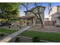 Inviting two-story home with desert landscaping, covered porch, and classic architectural details at 3678 E Yeager Ct, Gilbert, AZ 85295