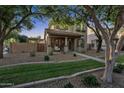 Beautiful two-story home boasting mature trees, a covered porch, and a well-manicured lawn at 3678 E Yeager Ct, Gilbert, AZ 85295
