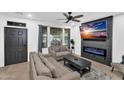 Stylish living room featuring a modern fireplace, large windows, and comfortable seating at 3678 E Yeager Ct, Gilbert, AZ 85295