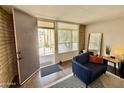 Welcoming entryway featuring a cozy sitting area and view to exterior patio at 3737 E Turney Ave # 223, Phoenix, AZ 85018