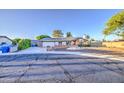 Charming single story home featuring a spacious driveway, two-car garage, and brick accents at 3906 W Aire Libre Ave, Phoenix, AZ 85053