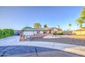 Charming single story home featuring a spacious driveway, two-car garage, and brick accents at 3906 W Aire Libre Ave, Phoenix, AZ 85053