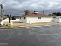 Street view featuring a white brick home with a brown roof and xeriscaping at 4701 N 39Th Dr, Phoenix, AZ 85019