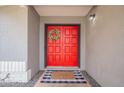 Close-up of the red double front doors with a welcome mat at 514 E Barrus Pl, Casa Grande, AZ 85122