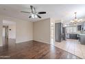 Open-concept living room featuring hardwood floors and views into the kitchen at 514 E Barrus Pl, Casa Grande, AZ 85122