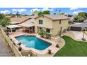 Aerial view showcasing the pool, covered patio, landscaped yard and the home's architecture at 609 W Mcnair St, Chandler, AZ 85225