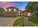 Charming two-story home with stone accents, a well-manicured lawn, and a welcoming walkway at 609 W Mcnair St, Chandler, AZ 85225