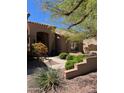 Lovely home exterior featuring a landscaped yard, walkway, and desert plants at 9059 E Butherus Dr, Scottsdale, AZ 85260