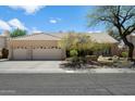 Charming single-story home with a three-car garage, tiled roof, and mature landscaping in a well-maintained community at 9059 E Butherus Dr, Scottsdale, AZ 85260