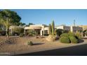 Charming home featuring desert landscaping with cacti, gravel, and plants for a unique curb appeal at 9726 E Hidden Green Dr, Scottsdale, AZ 85262