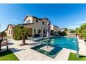 A private backyard oasis features a stunning pool, spa, and lush landscaping perfect for outdoor entertaining at 18101 N Crestview Ln, Maricopa, AZ 85138