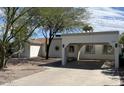 Single-story home featuring a covered carport and drought-resistant landscaping, perfect for low-maintenance living at 3907 E Marilyn Rd, Phoenix, AZ 85032
