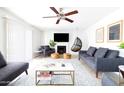 Spacious living room with comfortable seating, fireplace, and ceiling fan at 3907 E Marilyn Rd, Phoenix, AZ 85032