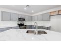 Modern kitchen featuring gray cabinets, quartz countertops, and stainless steel appliances with lots of light at 1096 E Rolls E Rd, San Tan Valley, AZ 85143
